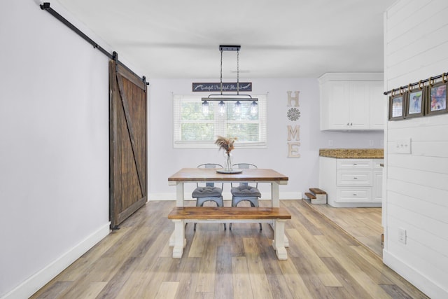 1861 Jaywood Cir, Charleston, SC 29407 - dining room with a barn door, light wood-type flooring, and baseboards