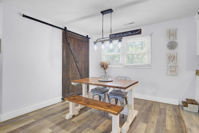 1861 Jaywood Cir, Charleston, SC 29407 - dining room featuring a barn door, light wood-style floors, visible vents, and baseboards