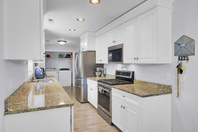 1861 Jaywood Cir, Charleston, SC 29407 - kitchen with recessed lighting, stainless steel appliances, a sink, washing machine and clothes dryer, and white cabinetry