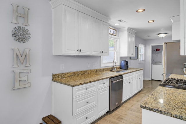1861 Jaywood Cir, Charleston, SC 29407 - kitchen featuring white cabinets, a sink, appliances with stainless steel finishes, and washer / dryer