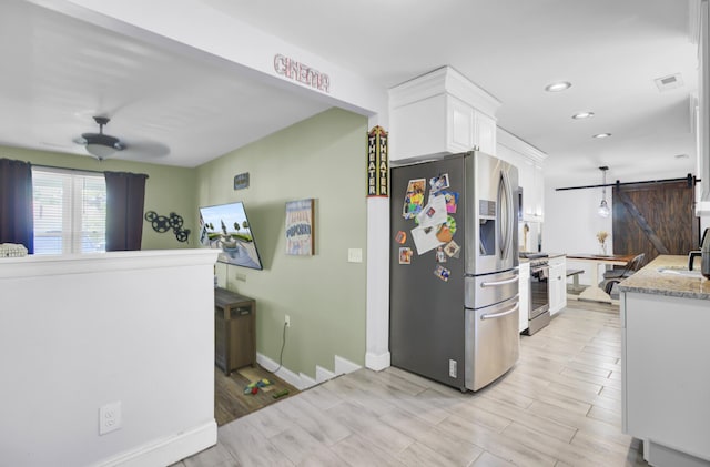 1861 Jaywood Cir, Charleston, SC 29407 - kitchen with white cabinets, a barn door, visible vents, a ceiling fan, and appliances with stainless steel finishes