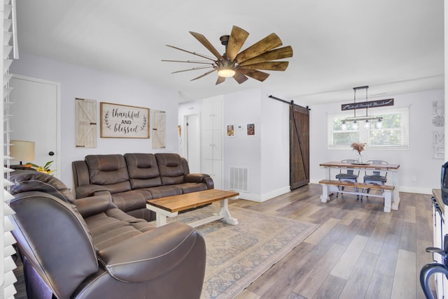 1861 Jaywood Cir, Charleston, SC 29407 - living area featuring a barn door, a ceiling fan, wood finished floors, baseboards, and visible vents