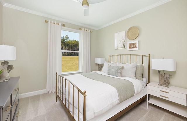 carpeted bedroom featuring a ceiling fan, ornamental molding, and baseboards