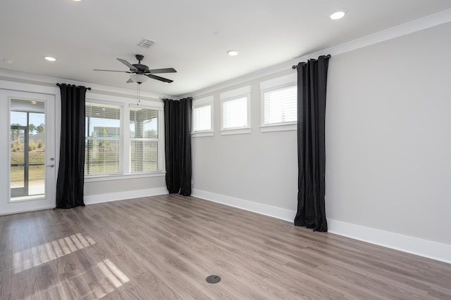 unfurnished room with light wood-style flooring, plenty of natural light, and visible vents