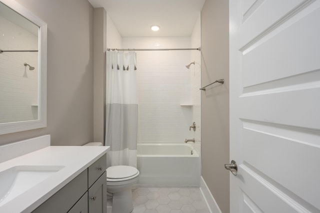 bathroom with toilet, vanity, tile patterned flooring, baseboards, and shower / bath combination with curtain