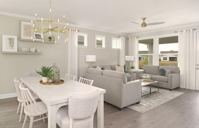 dining area featuring a ceiling fan, crown molding, baseboards, and wood finished floors