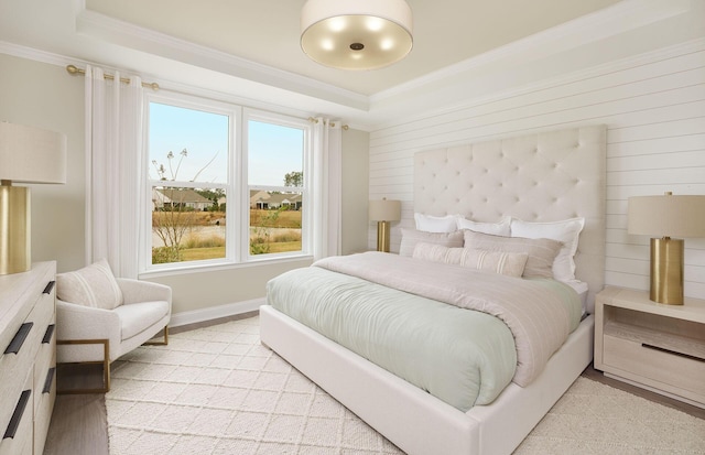 bedroom featuring a tray ceiling and ornamental molding
