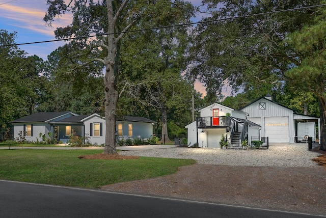 view of front of property with a yard and a garage