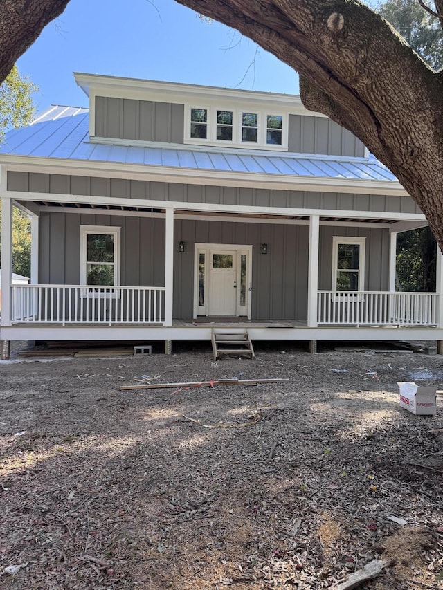 view of front of house with a standing seam roof, a porch, and board and batten siding