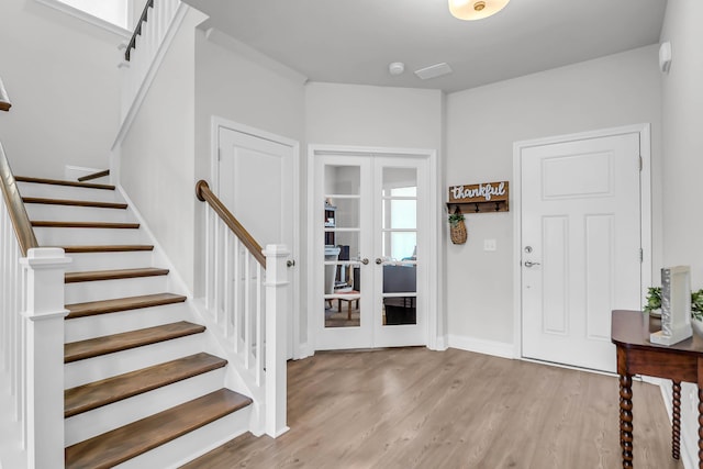 entrance foyer featuring light hardwood / wood-style flooring and french doors