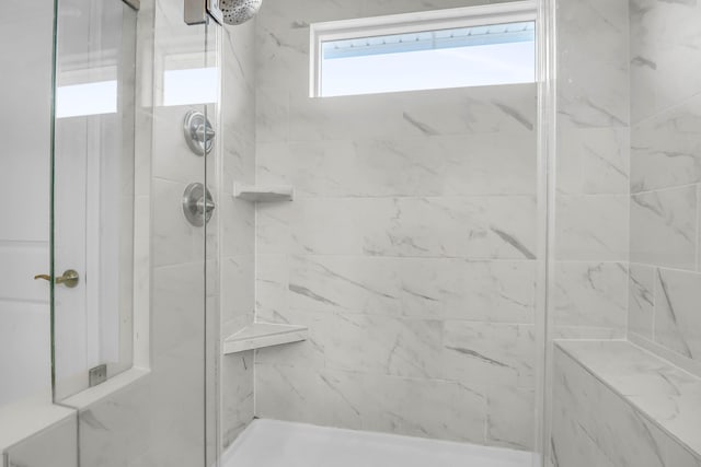 bathroom with a tile shower