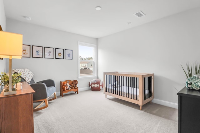 bedroom with carpet flooring and a nursery area