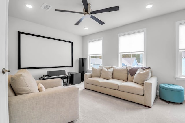 carpeted home theater room featuring ceiling fan