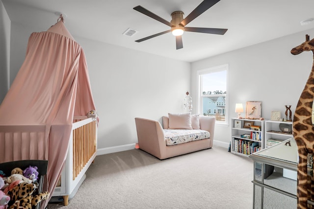 sitting room with ceiling fan and carpet floors