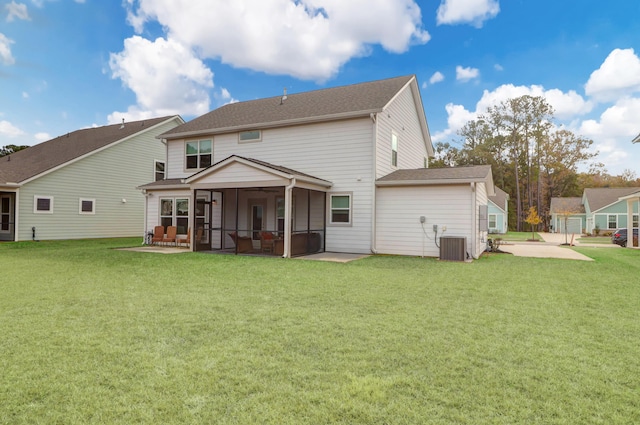 back of property featuring central air condition unit, a patio area, a sunroom, and a lawn