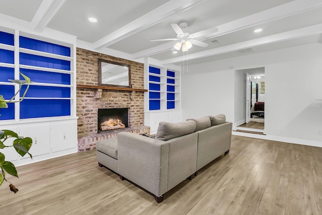 1909 Swift Ave, Charleston, SC 29407 - living area featuring beam ceiling, wood finished floors, a ceiling fan, built in shelves, and a brick fireplace