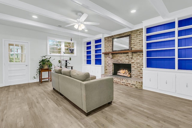 1909 Swift Ave, Charleston, SC 29407 - living room with beamed ceiling, light wood-style flooring, a ceiling fan, a brick fireplace, and built in features