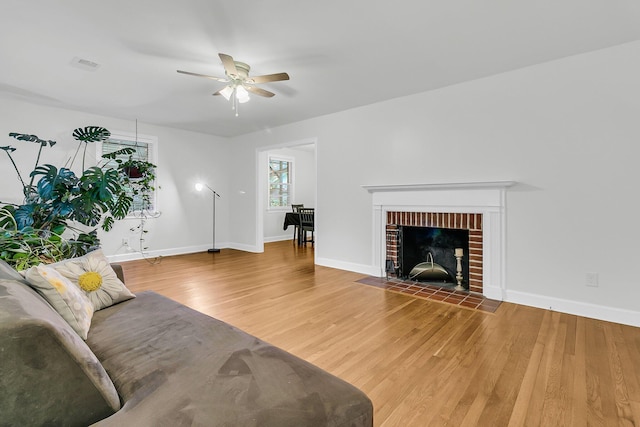 1909 Swift Ave, Charleston, SC 29407 - living room with ceiling fan, wood finished floors, and a brick fireplace