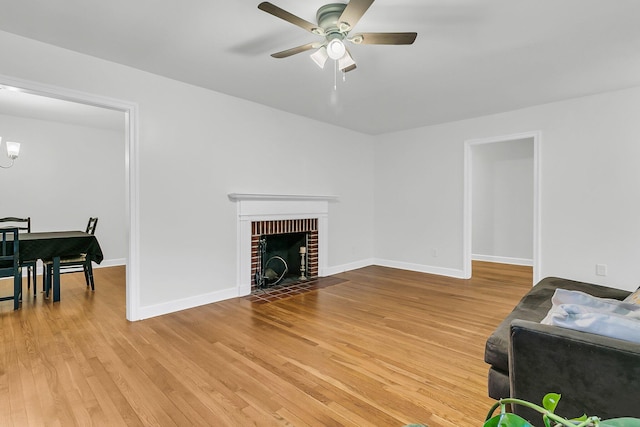 1909 Swift Ave, Charleston, SC 29407 - living area with ceiling fan, light wood-style floors, and a brick fireplace