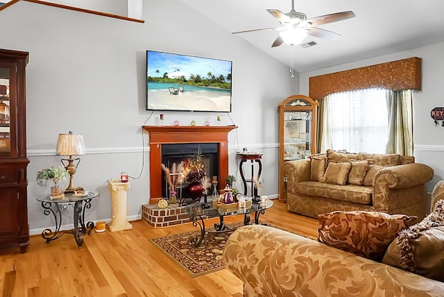 8692 Bentwood Dr, North Charleston, SC 29406 - living room featuring vaulted ceiling, ceiling fan, wood finished floors, and a lit fireplace