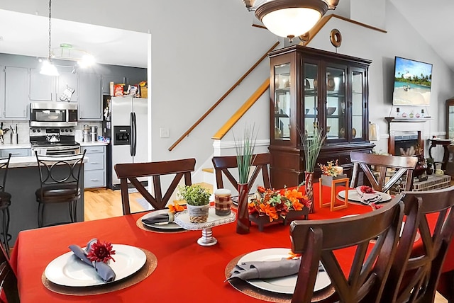 8692 Bentwood Dr, North Charleston, SC 29406 - dining area featuring light wood-style floors and vaulted ceiling