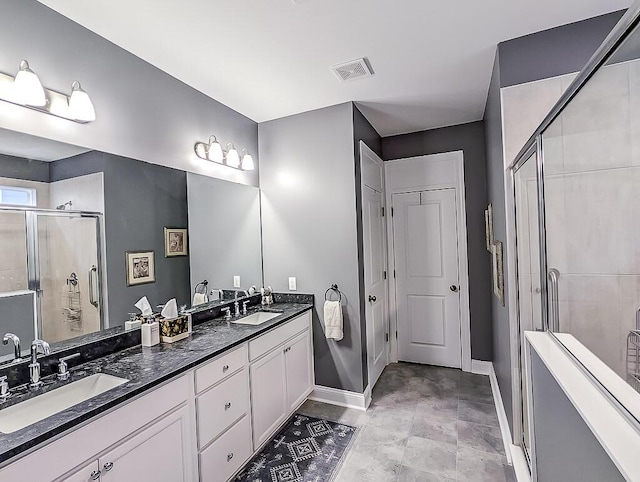 bathroom featuring an enclosed shower and vanity