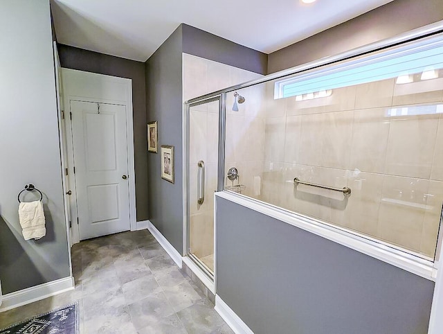 bathroom featuring a shower with door