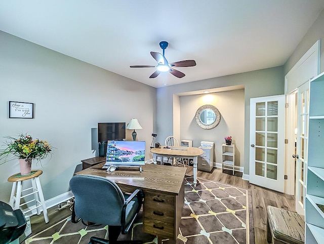 office featuring ceiling fan, light wood-type flooring, and french doors