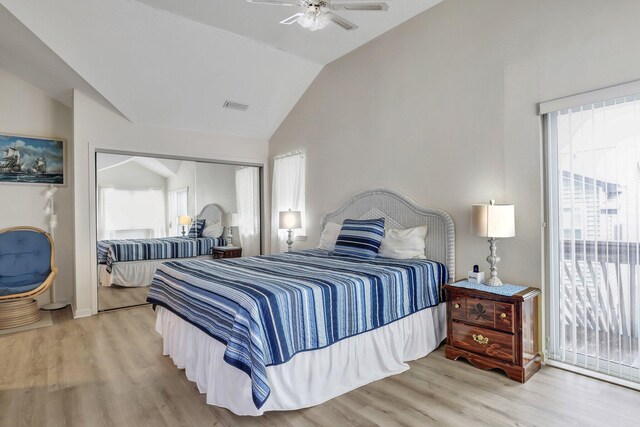 bedroom with a closet, ceiling fan, light hardwood / wood-style flooring, and lofted ceiling