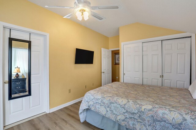 bathroom featuring ceiling fan, a shower with curtain, lofted ceiling, vanity, and hardwood / wood-style flooring