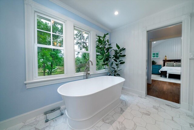 375 Seewee Cir, Mount Pleasant, SC 29464 - bathroom with a soaking tub, ornamental molding, connected bathroom, baseboards, and tile patterned flooring
