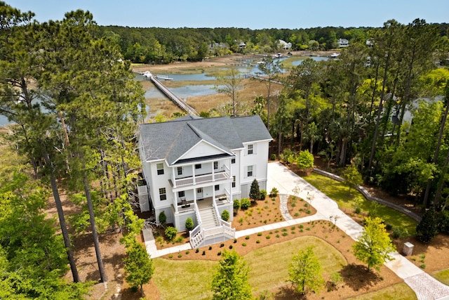 drone / aerial view featuring a water view and a forest view