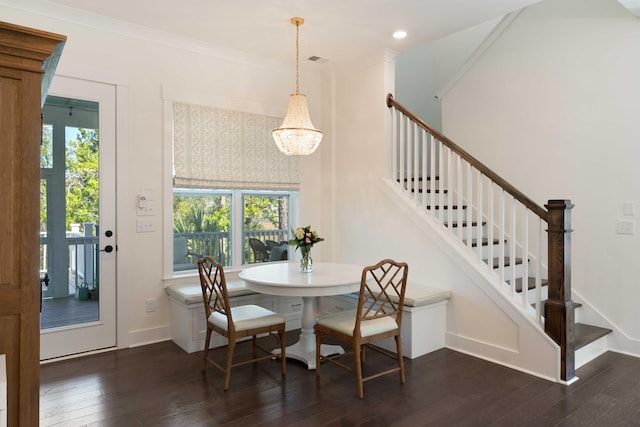 dining space with hardwood / wood-style flooring, baseboards, stairs, and a chandelier