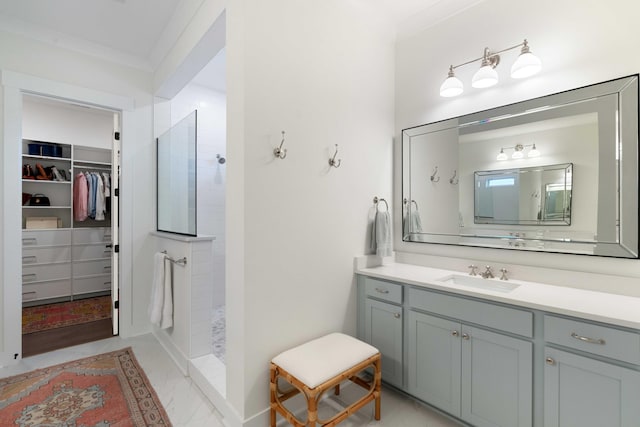 full bathroom with vanity, a walk in shower, crown molding, and a spacious closet