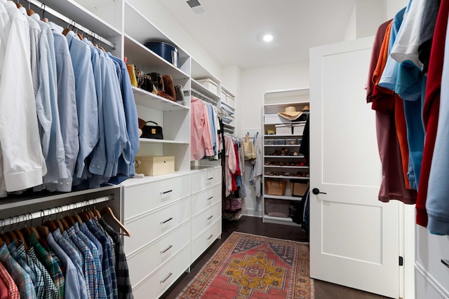 spacious closet featuring visible vents and dark wood-type flooring