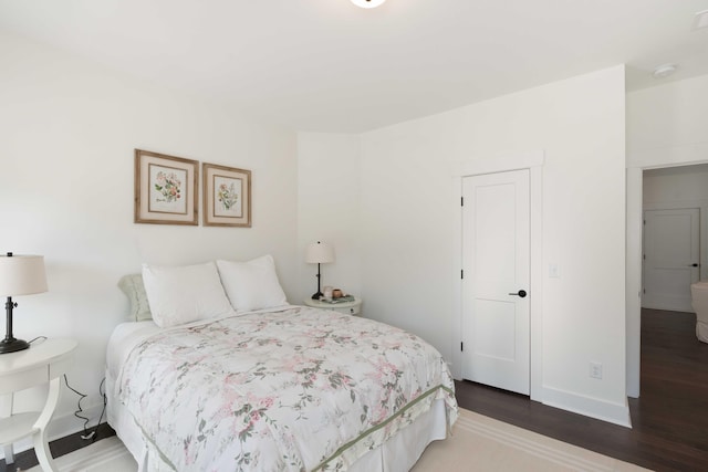 bedroom featuring baseboards and wood finished floors