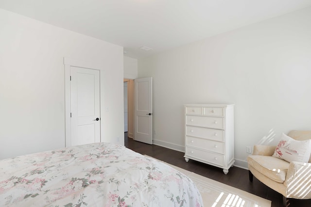 bedroom featuring baseboards and dark wood-style floors