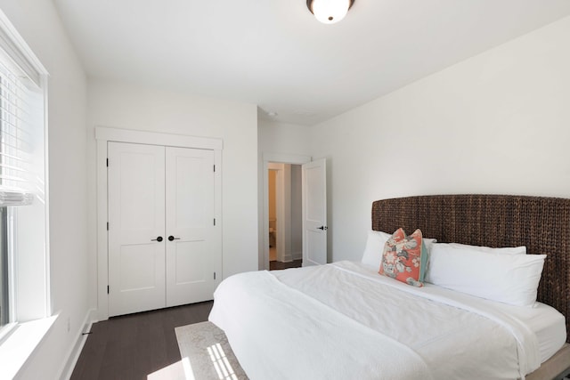bedroom featuring a closet and dark wood-style flooring