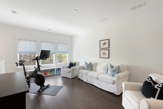 workout area featuring dark wood finished floors and visible vents