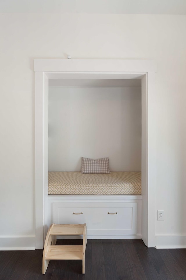 room details featuring baseboards and wood finished floors