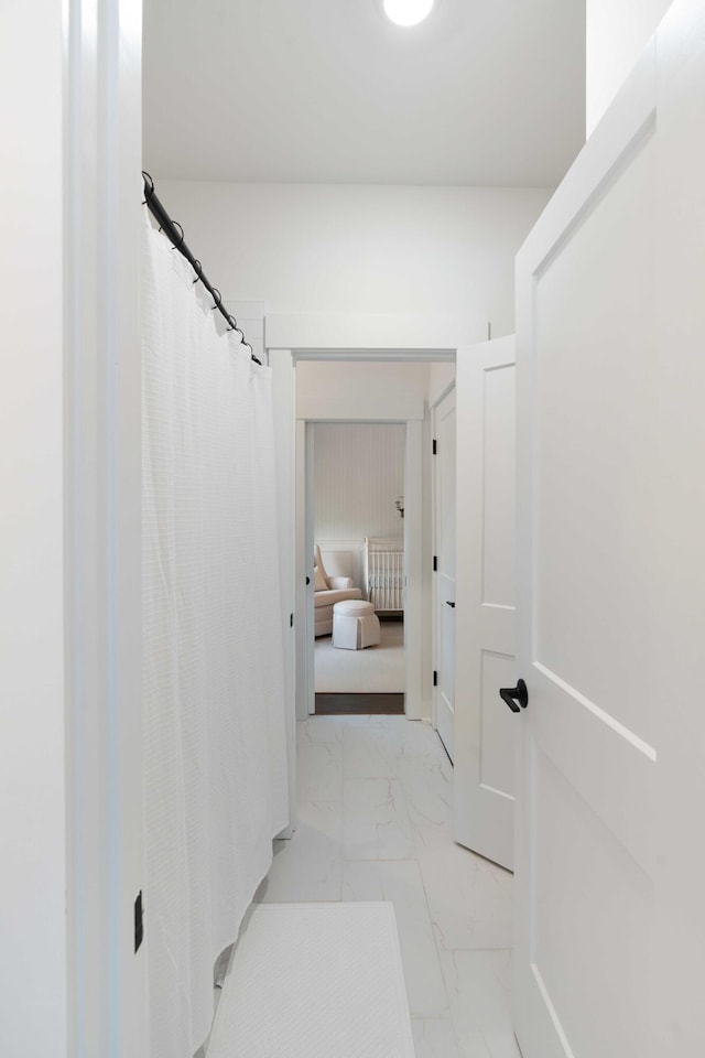 corridor featuring marble finish floor