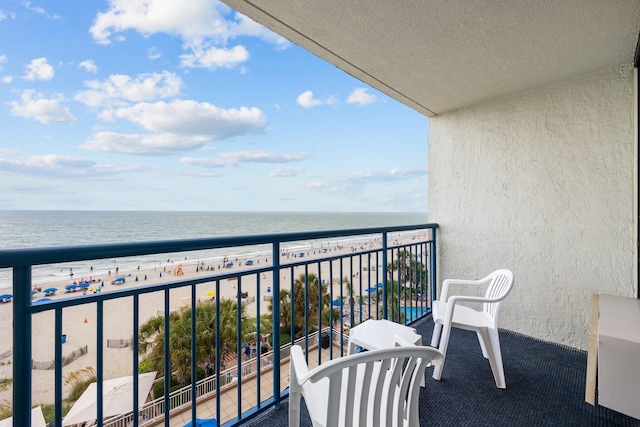 balcony with a view of the beach and a water view