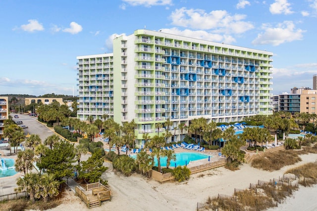 view of building exterior featuring a community pool