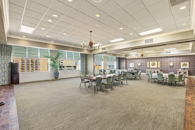 carpeted dining room with an inviting chandelier