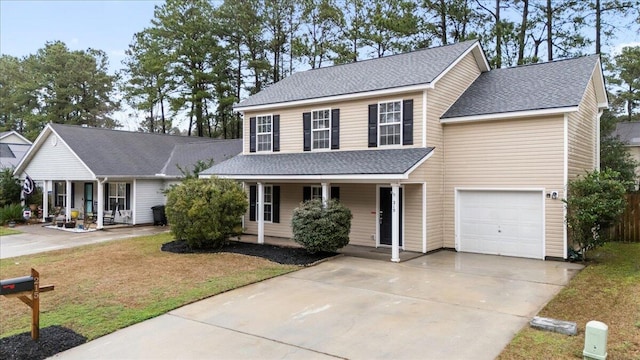 front of property featuring a garage, a front lawn, and a porch