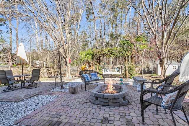 544 Beverly Dr, Summerville, SC 29485 - view of patio with an outbuilding, a shed, a fenced backyard, a fire pit, and outdoor dining area