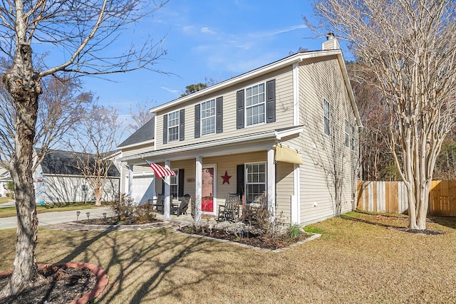 view of front of house with a chimney, covered porch, fence, driveway, and a front lawn