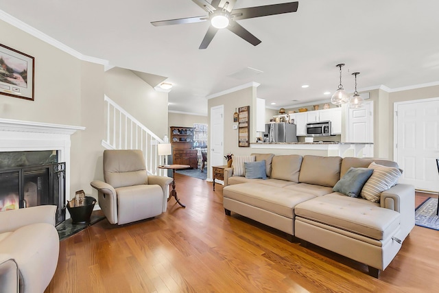 544 Beverly Dr, Summerville, SC 29485 - living area with crown molding, ceiling fan, light wood-type flooring, and stairway