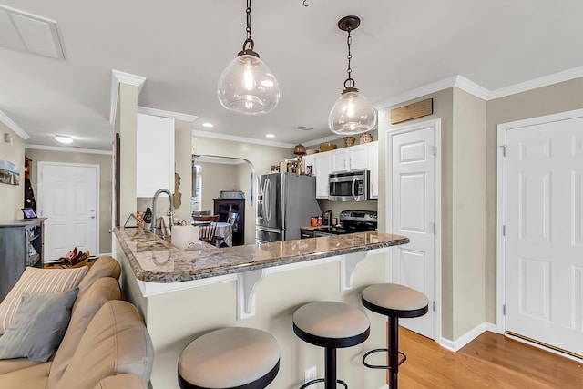 544 Beverly Dr, Summerville, SC 29485 - kitchen featuring ornamental molding, a kitchen breakfast bar, white cabinets, and stainless steel appliances