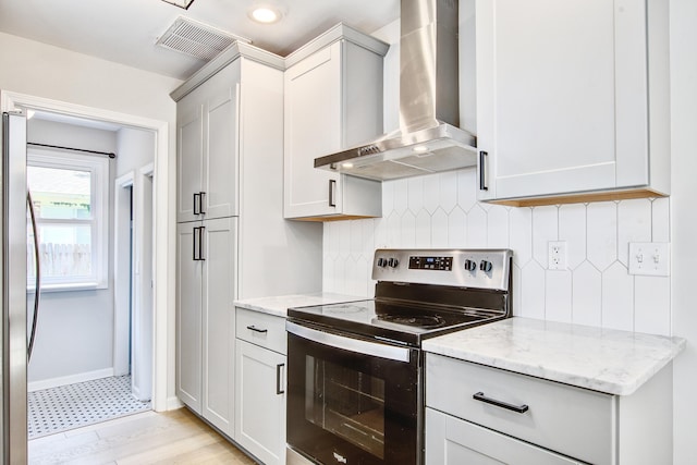 1052 Yorktown Dr, Charleston, SC 29412 - kitchen with electric stove, wall chimney exhaust hood, freestanding refrigerator, tasteful backsplash, and light stone counters